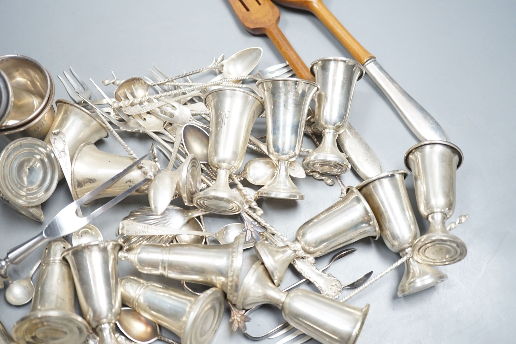 A quantity of American sterling items including four beakers, twelve assorted small goblets(weighted?), six assorted condiments(weighted?) and group of miscellaneous flatware